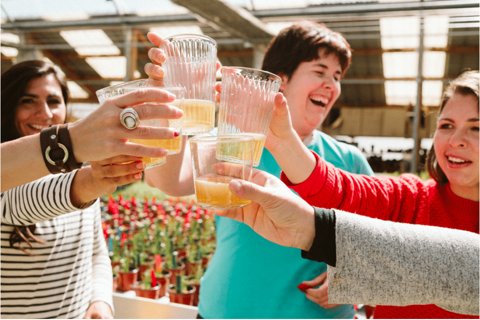 friends cheering with a glass of cider